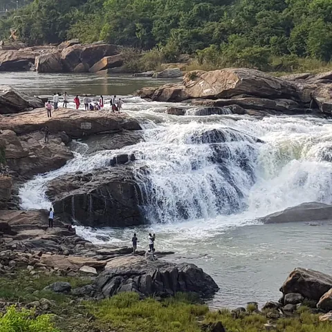 Chunchanakatte Falls in spate, with visitors on the rocks above