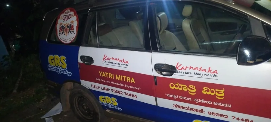 The side of the vehicle, with the helpline number along the door